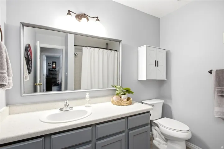 Vanity with an integrated sink, brushed nickel faucet, and gray cabinetry