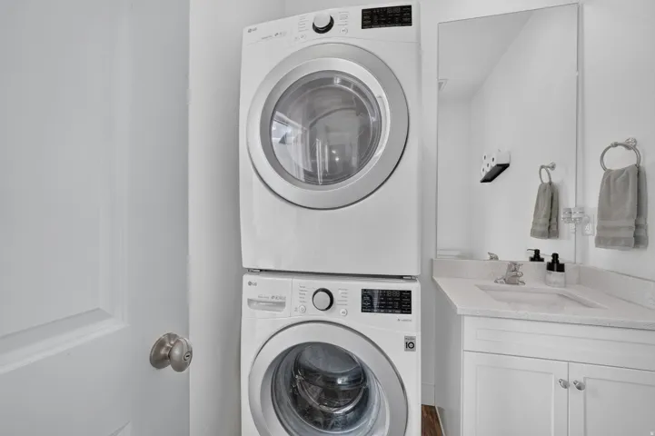 Stacked washer and dryer units in half bathroom