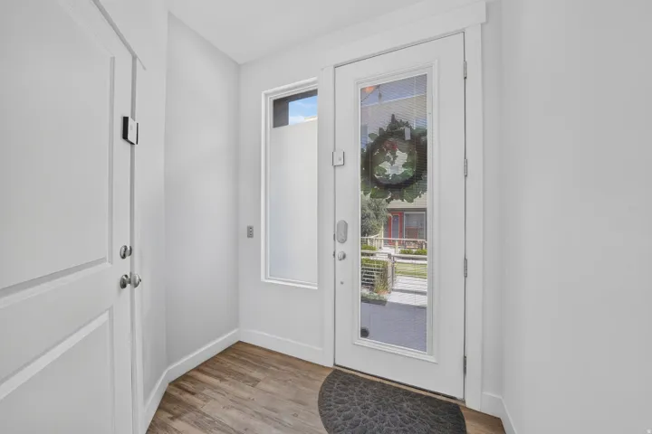 Wood-finish flooring with a white paneled door