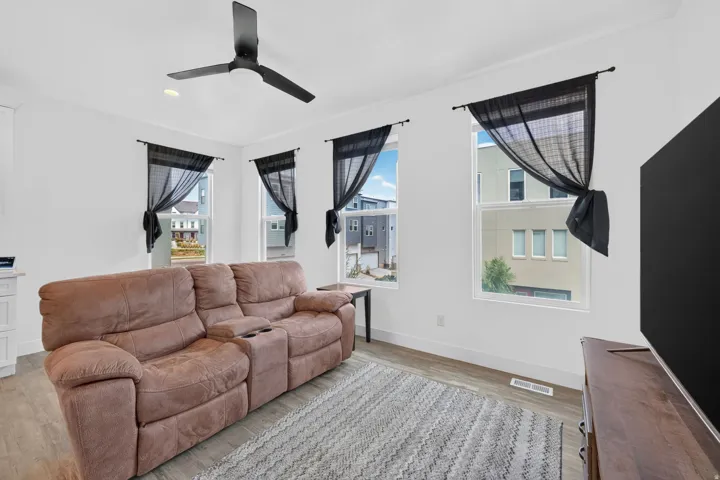 White walls, wood-finish flooring, and recessed ceiling lighting
