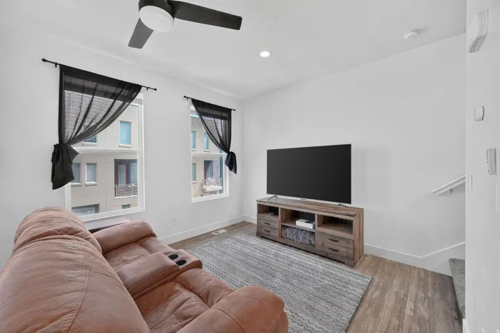 Recessed lighting, wood-finish flooring, and a ceiling fan