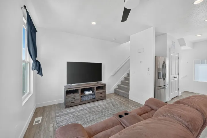 Open-concept living space with wood-finish flooring, recessed lighting