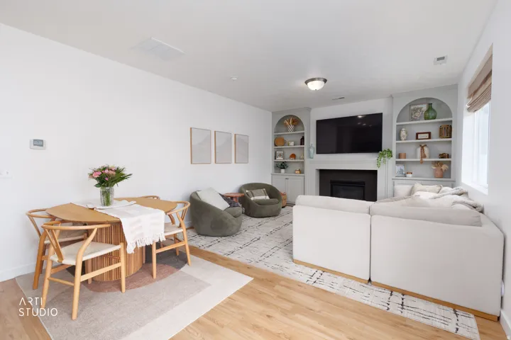 Wood-finish flooring throughout the living space with custom built-in arched shelves