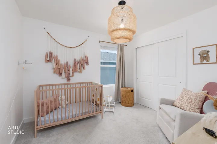 Plush carpet flooring, a large window with drapes, and a built-in closet with sliding panel doors