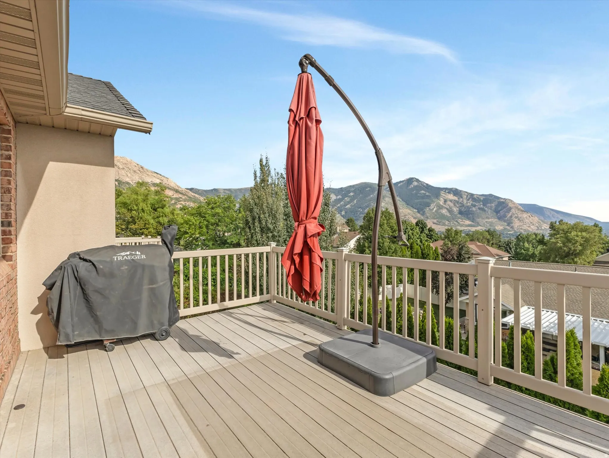 Amazing Views!  Second deck off Master Suite with with composite flooring, white railing, and mountain backdrop