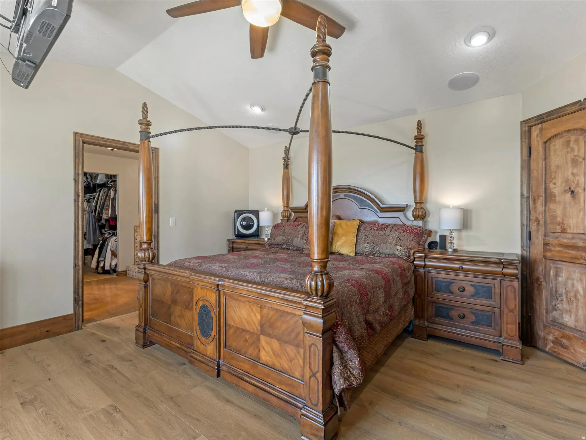 Master Bedroom - Vaulted ceiling with recessed lighting and a ceiling fan, wood-finish flooring, and a solid wood door