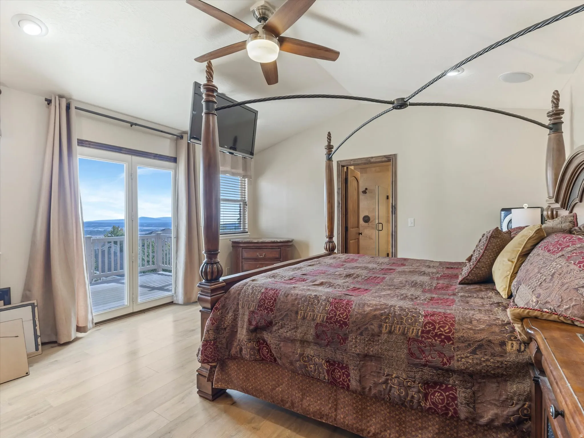 Master Bedroom with Walkout Deck, Wood-finish flooring, recessed lighting, and a ceiling fan