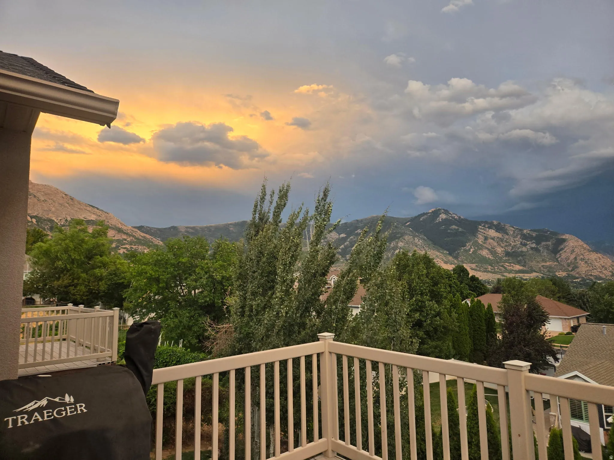 Balcony featuring a beige railing and mountain backdrop