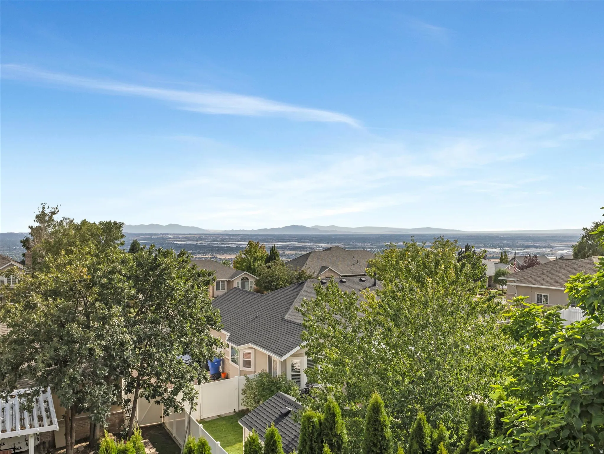 Elevated hilltop setting with expansive vistas across rolling valleys and distant mountain ranges