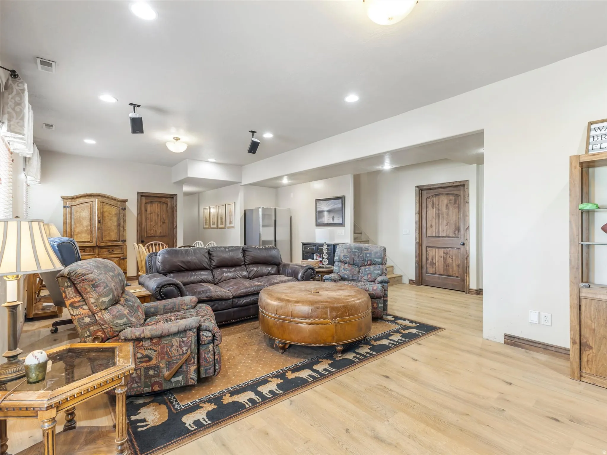Recessed ceiling lighting, wood-finish flooring, and natural wood doors