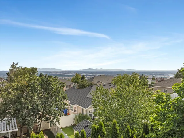 Elevated hilltop setting with expansive vistas across rolling valleys and distant mountain ranges