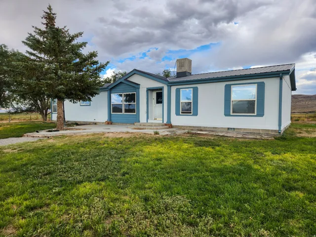 White siding exterior with blue trim and shutters