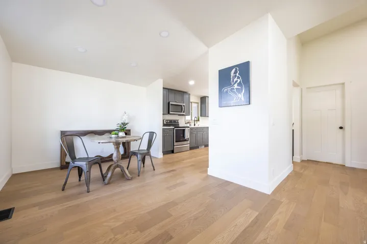 Hardwood-finish flooring, recessed lighting, and a paneled interior door