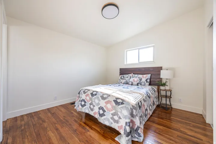 Hardwood flooring, neutral wall tones, recessed window, and flush-mount ceiling fixture