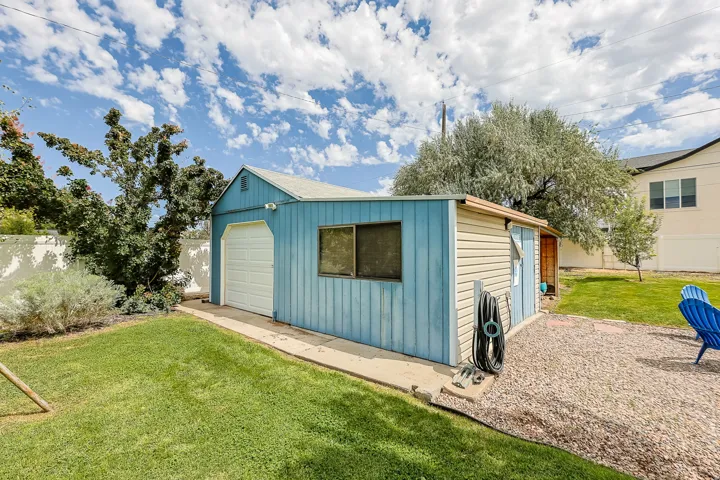 A detached storage shed provides convenient additional space for lawn equipment, tools, outdoor storage, or a potential workshop.