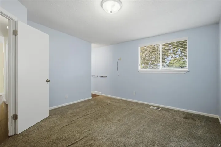 Wall-to-wall carpeting with light blue painted walls