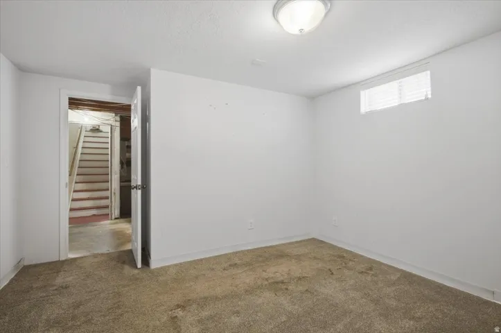 Carpeted flooring with white painted walls
