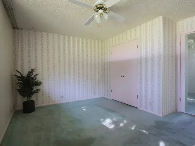 Recessed lighting, ceiling fan, carpeting, closet with bi-fold doors, and patterned wallpaper