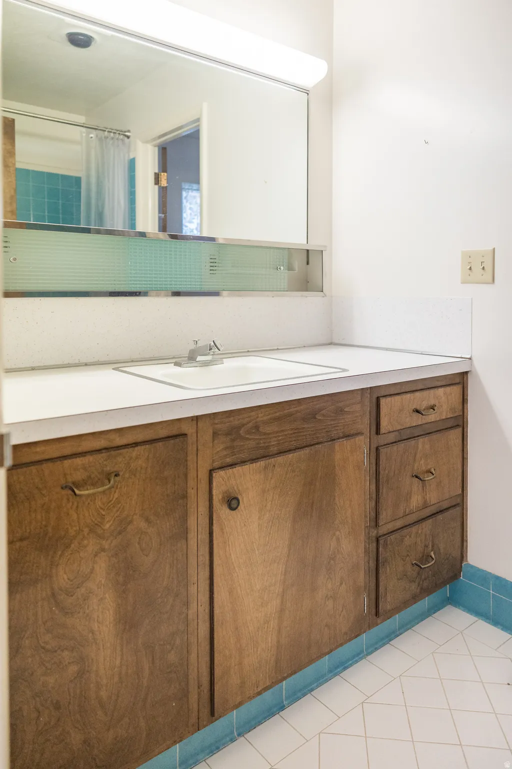 Recessed sink with a chrome faucet, set into a white countertop