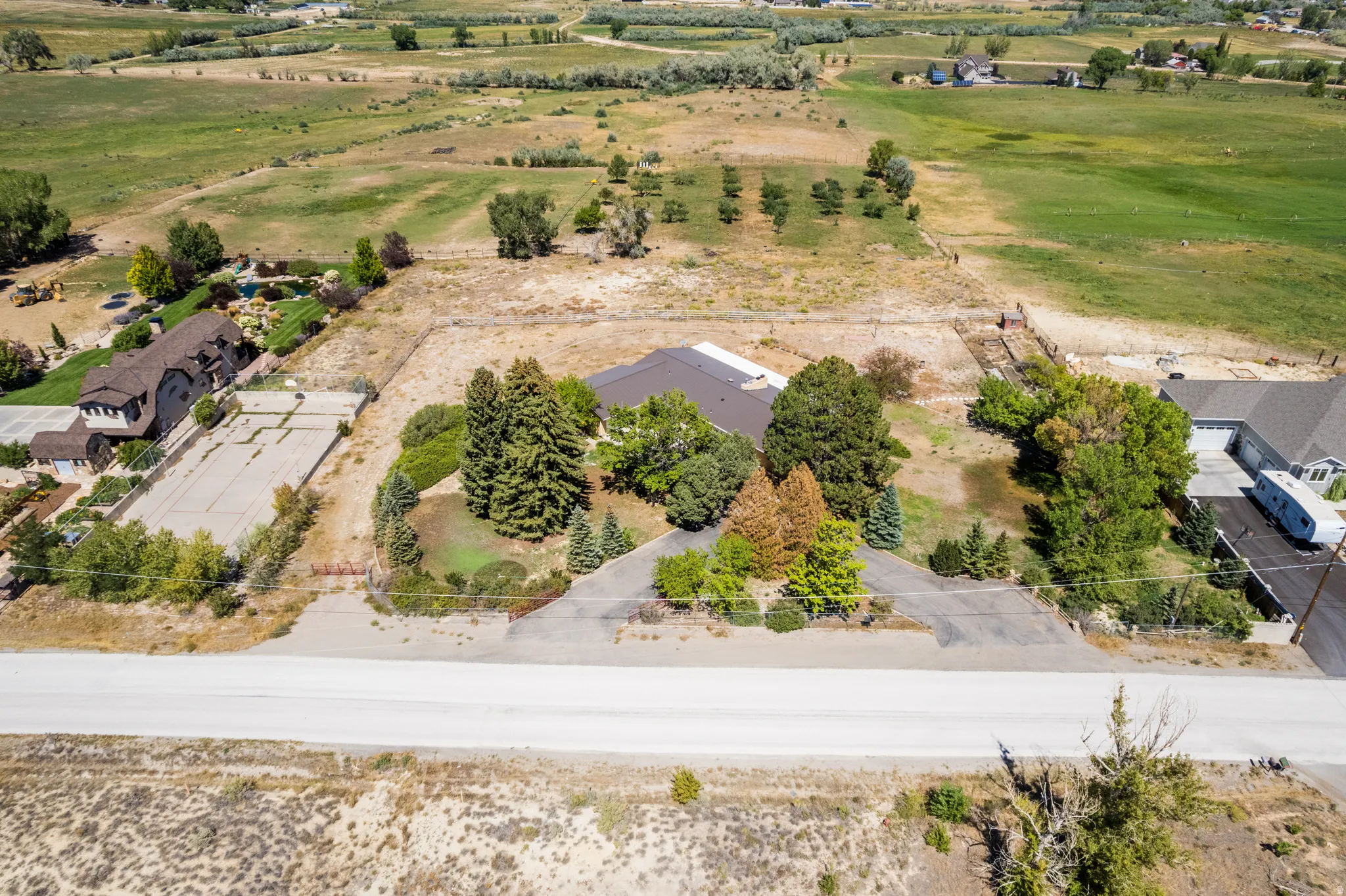 Expansive lot featuring mature trees, a private driveway, and surrounding open land