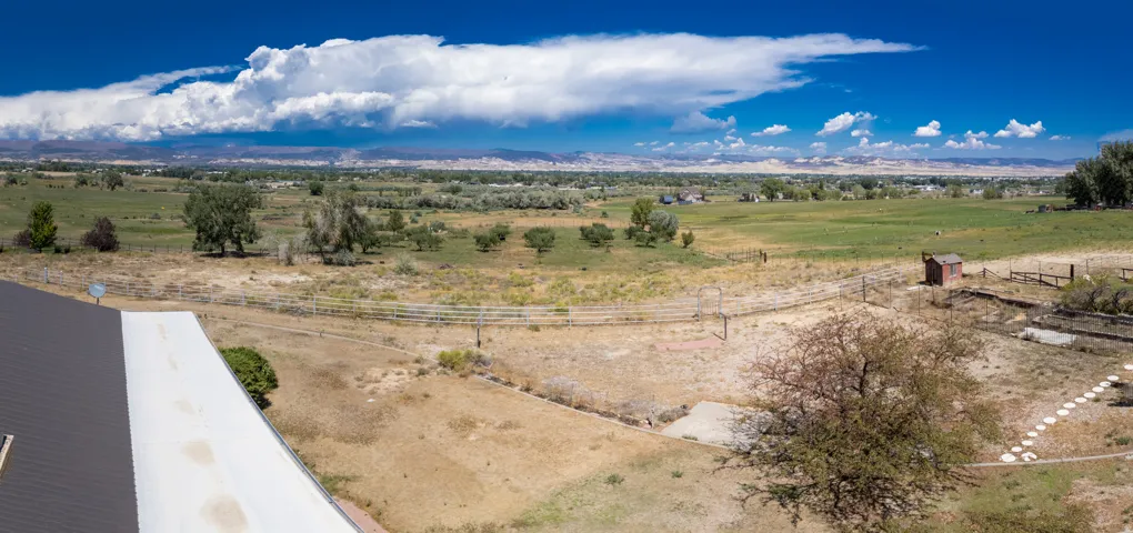 Expansive rural landscape with distant mountains under a broad sky