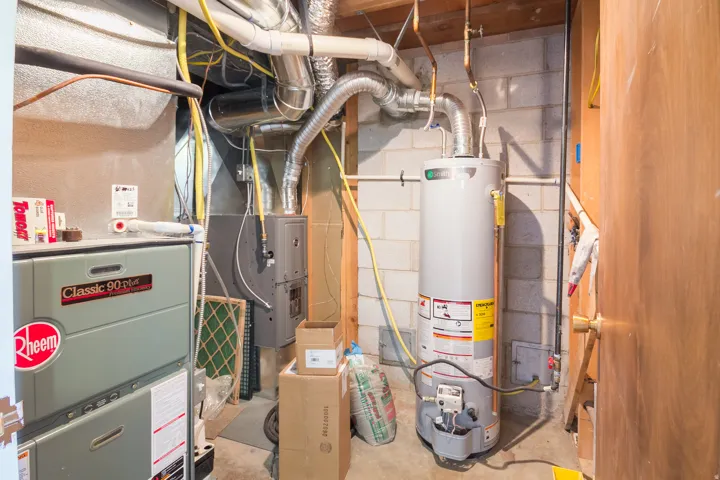 Utility area featuring a water heater and furnace