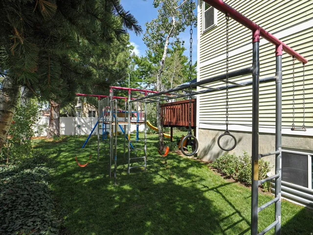 Expansive grassy yard with mature trees and established ground cover