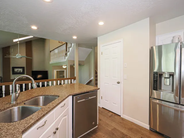 Kitchen island with stone-finish countertop and dual stainless steel sinks