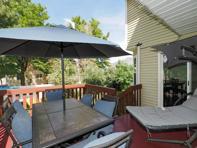 Elevated deck with wood railing, siding exterior, and sliding glass door access