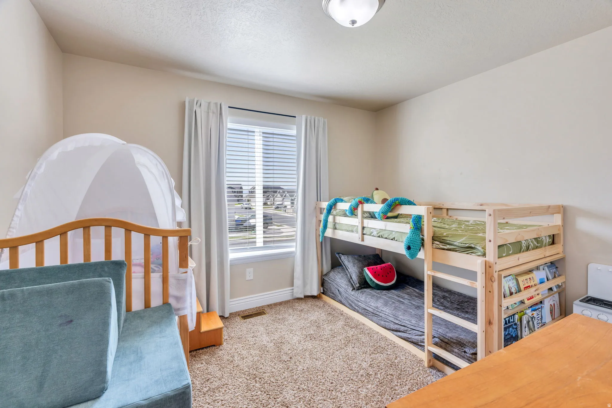 Recessed window with white blinds and curtains