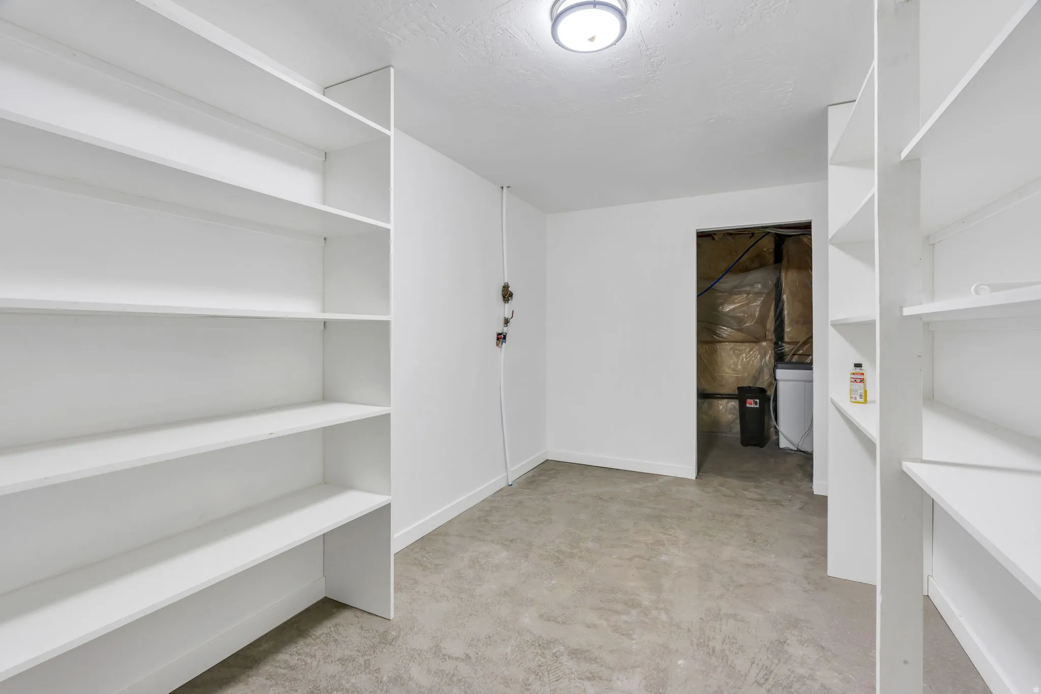 Concrete flooring with built-in shelving and recessed lighting