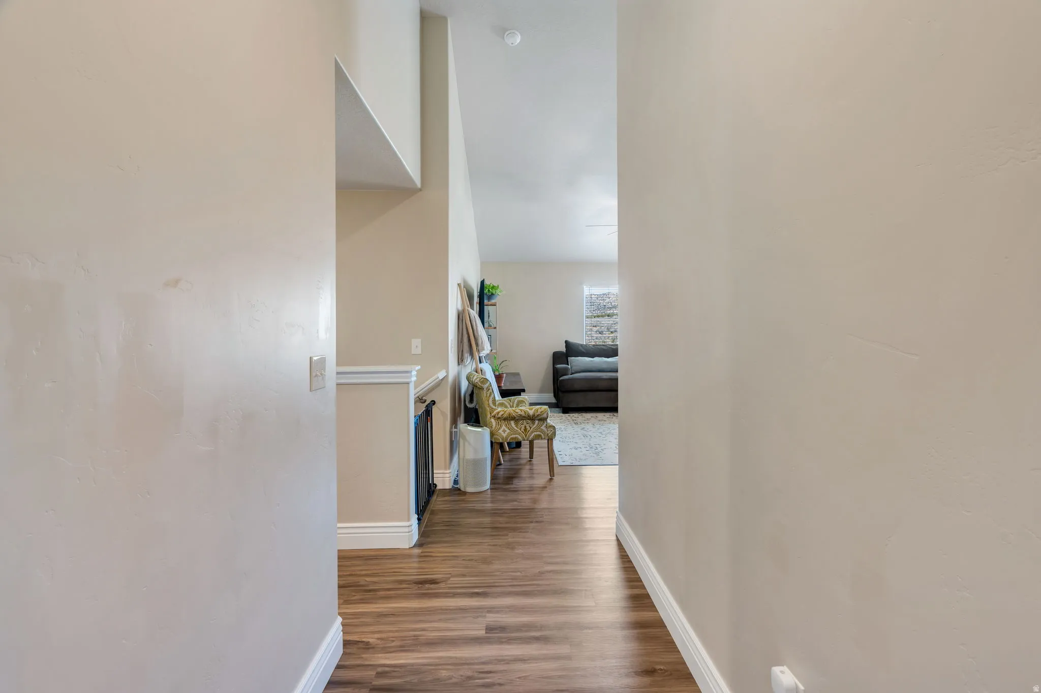 Wood-finish flooring throughout, with a recessed fireplace and a vaulted ceiling