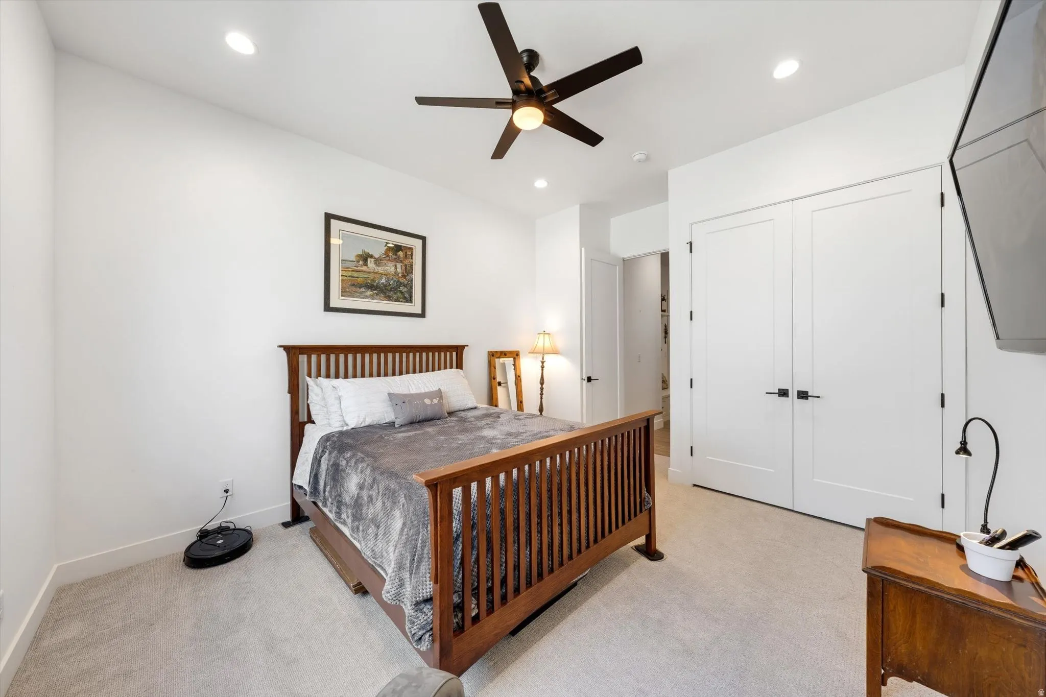 Recessed lighting and a ceiling fan provide illumination
