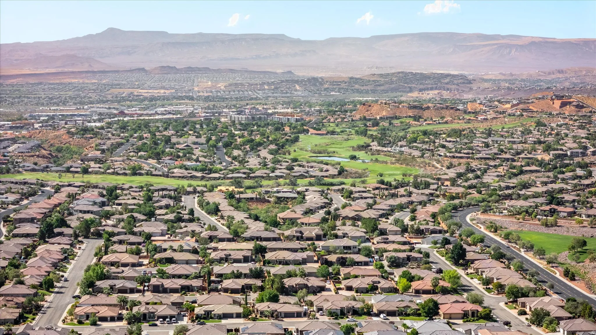 Expansive neighborhood with diverse residential architecture and mature landscaping