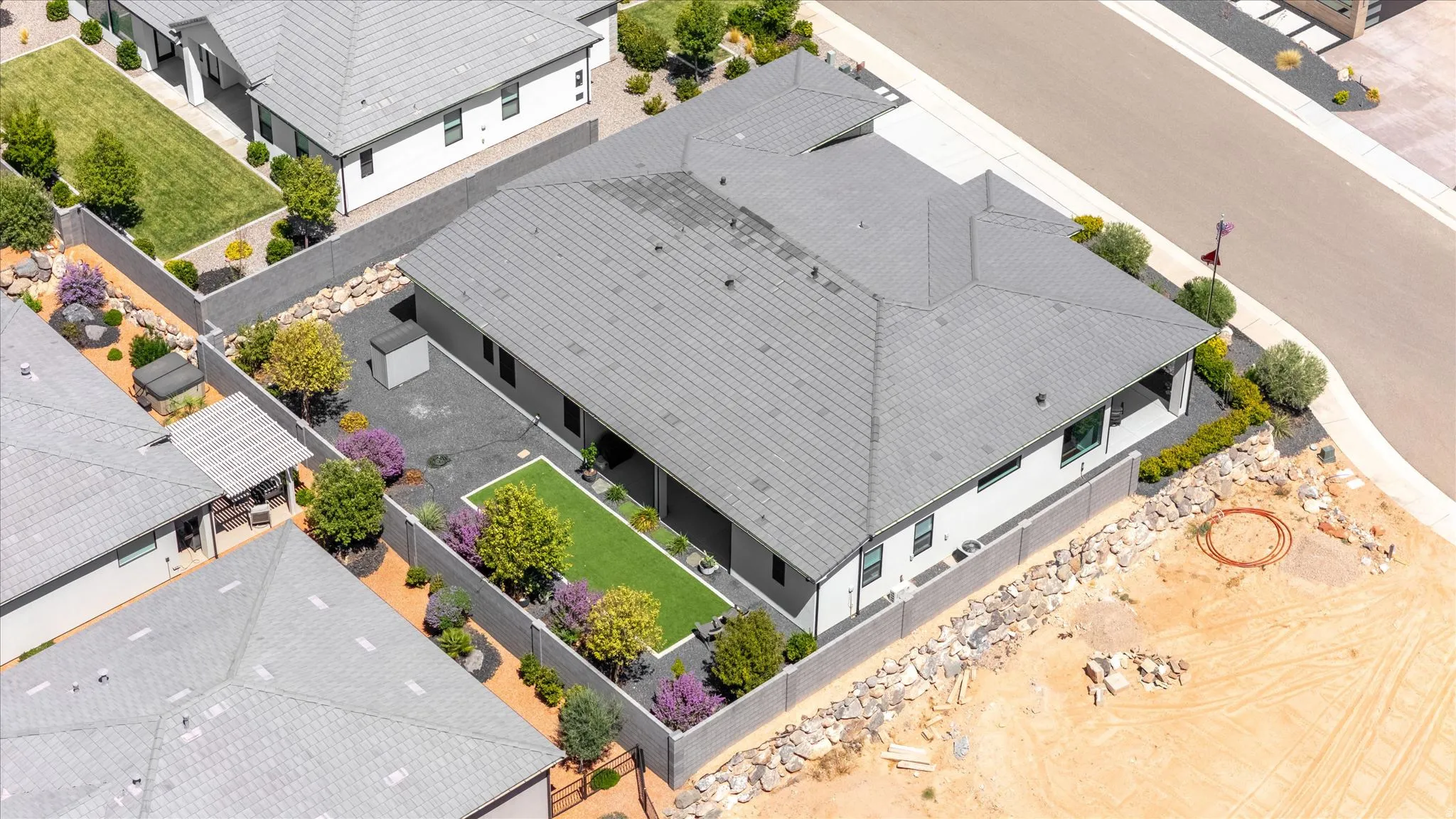 Contemporary residence with a gray tile roof and white exterior siding