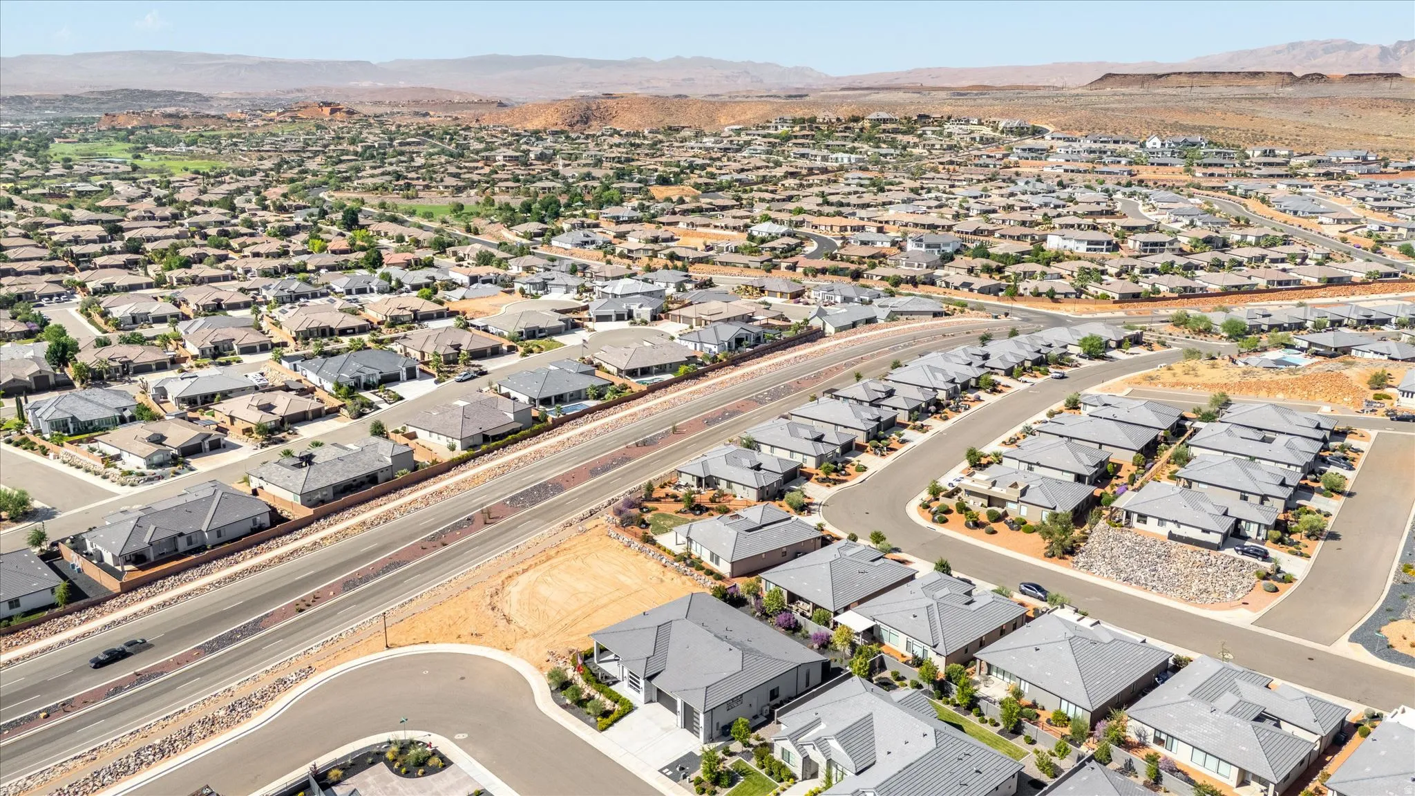 Expansive residential development featuring paved roads and desert landscaping