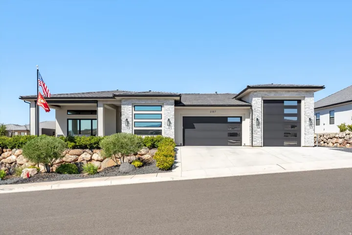Modern exterior with light stucco and stone veneer accents