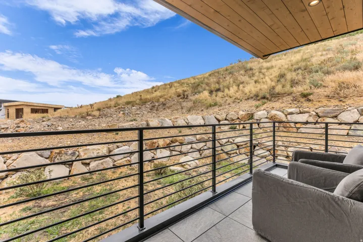 Outdoor patio with tiled flooring, metal railing, wood-finish ceiling, and recessed lighting