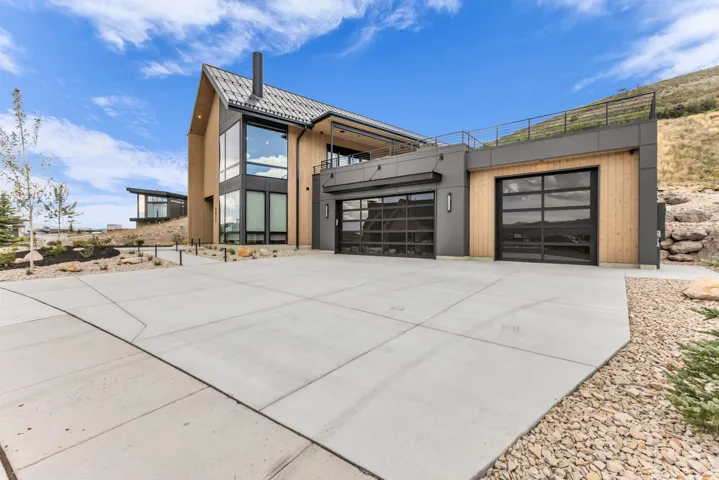 Contemporary architecture featuring a peaked metal roof and wood paneling