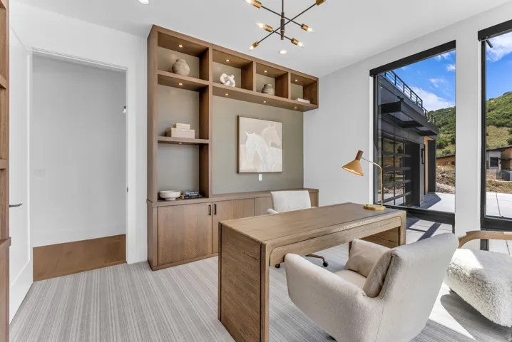 Built-in cabinetry with integrated shelving, recessed lighting, and a desk