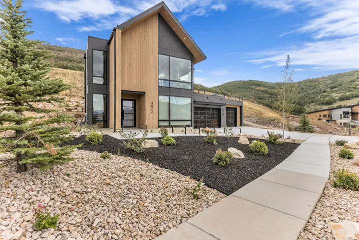 Contemporary exterior with wood-tone siding and dark panel accents