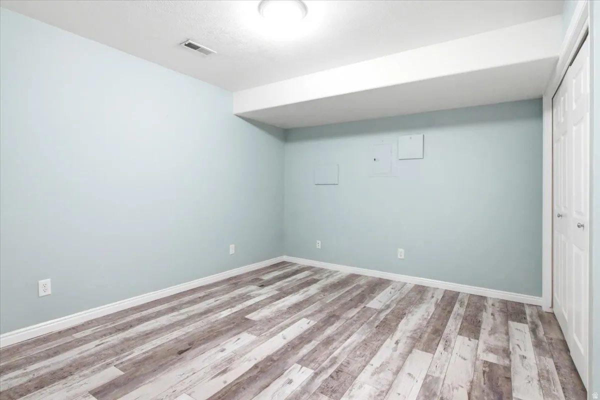 Flex Room: Office/Workout Space, etc. Wood-finish flooring, white trim, light blue walls, and bi-fold closet doors