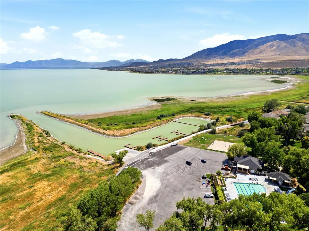 Utah Lake, mountain backdrop, boat docks, swimming pool, and clubhouse structure
