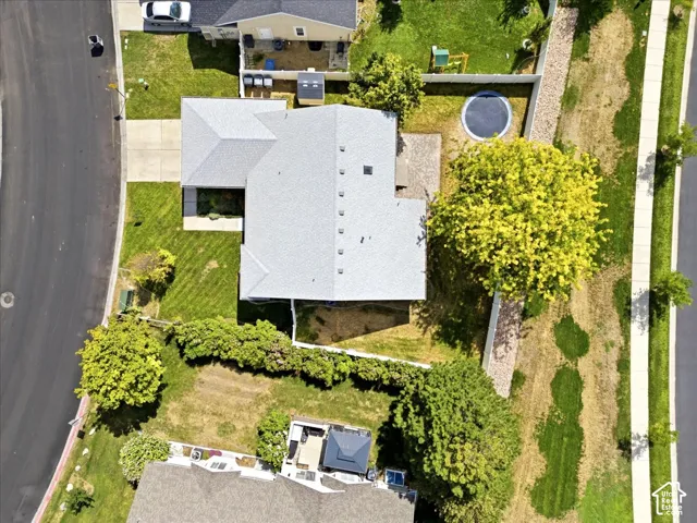 Aerial View of Home with Newer Gray Shingle Roof, Concrete Driveway, and Sizeable Yard