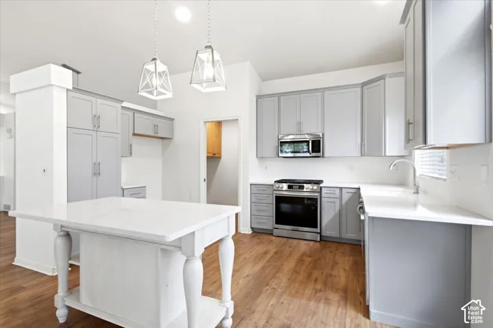 Updated Kitchen with Newer Cabinetry, Farmhouse Sink and Quartz Countertops. Coordinating Island and Stainless Steel Appliances.