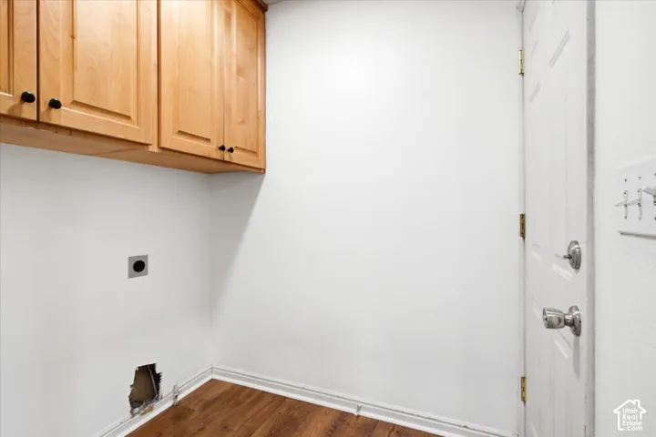 Convenient Laundry Room with Quality Hardwood Cabinetry.