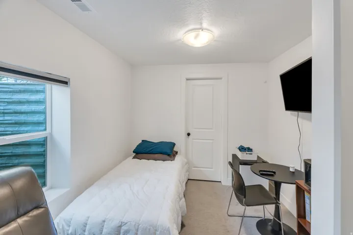 Private lower-level guest suite with bedroom and flexible living space.