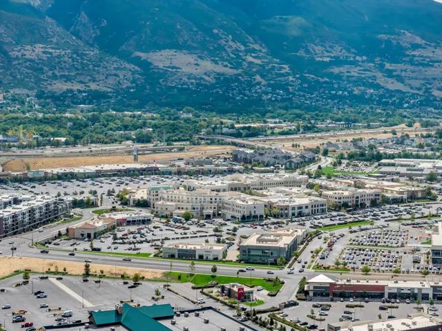 Wide aerial view of Farmington, Station Park and surrounding mountain setting.