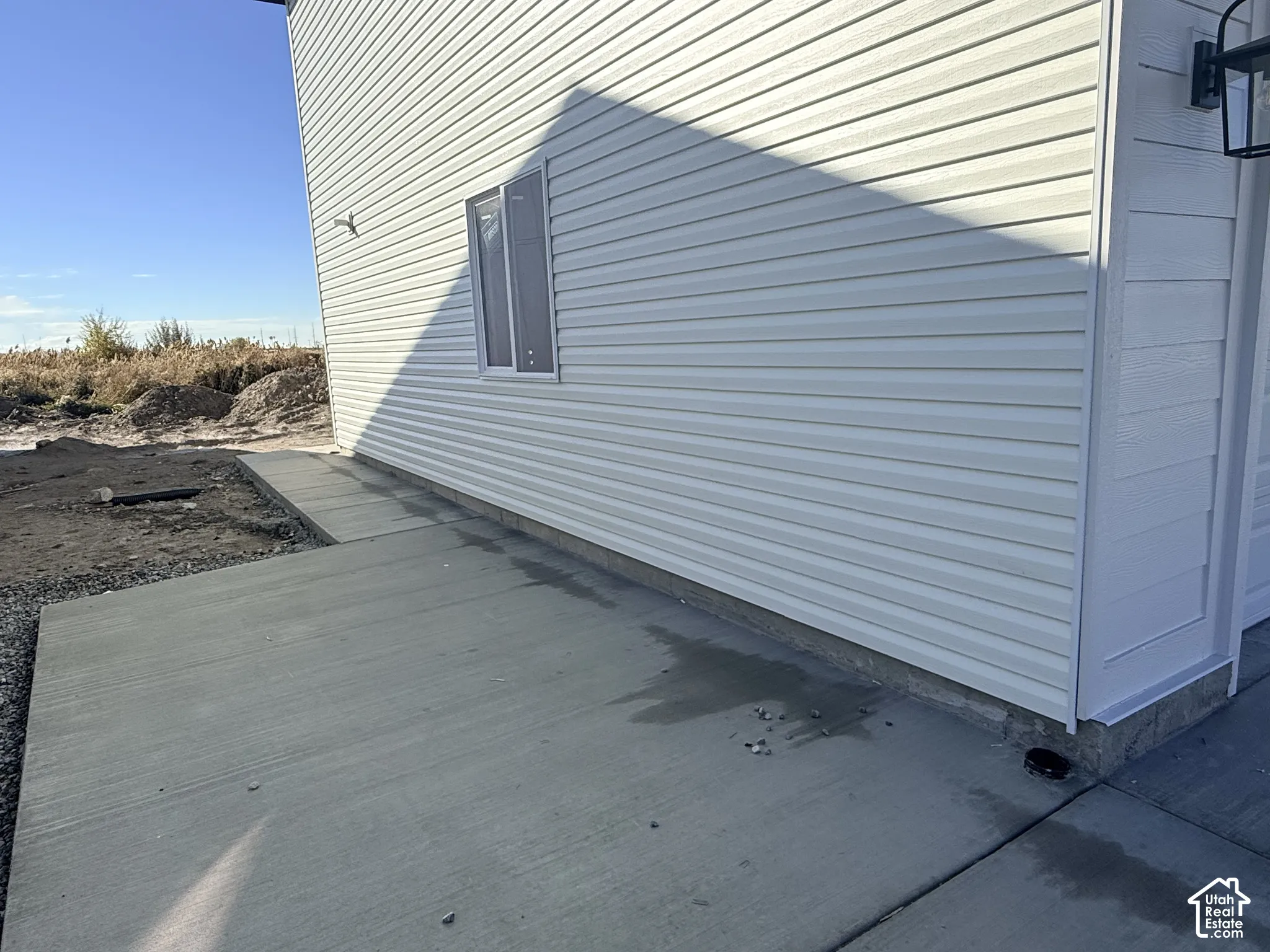 Exterior featuring horizontal vinyl siding, concrete foundation, and a concrete pathway