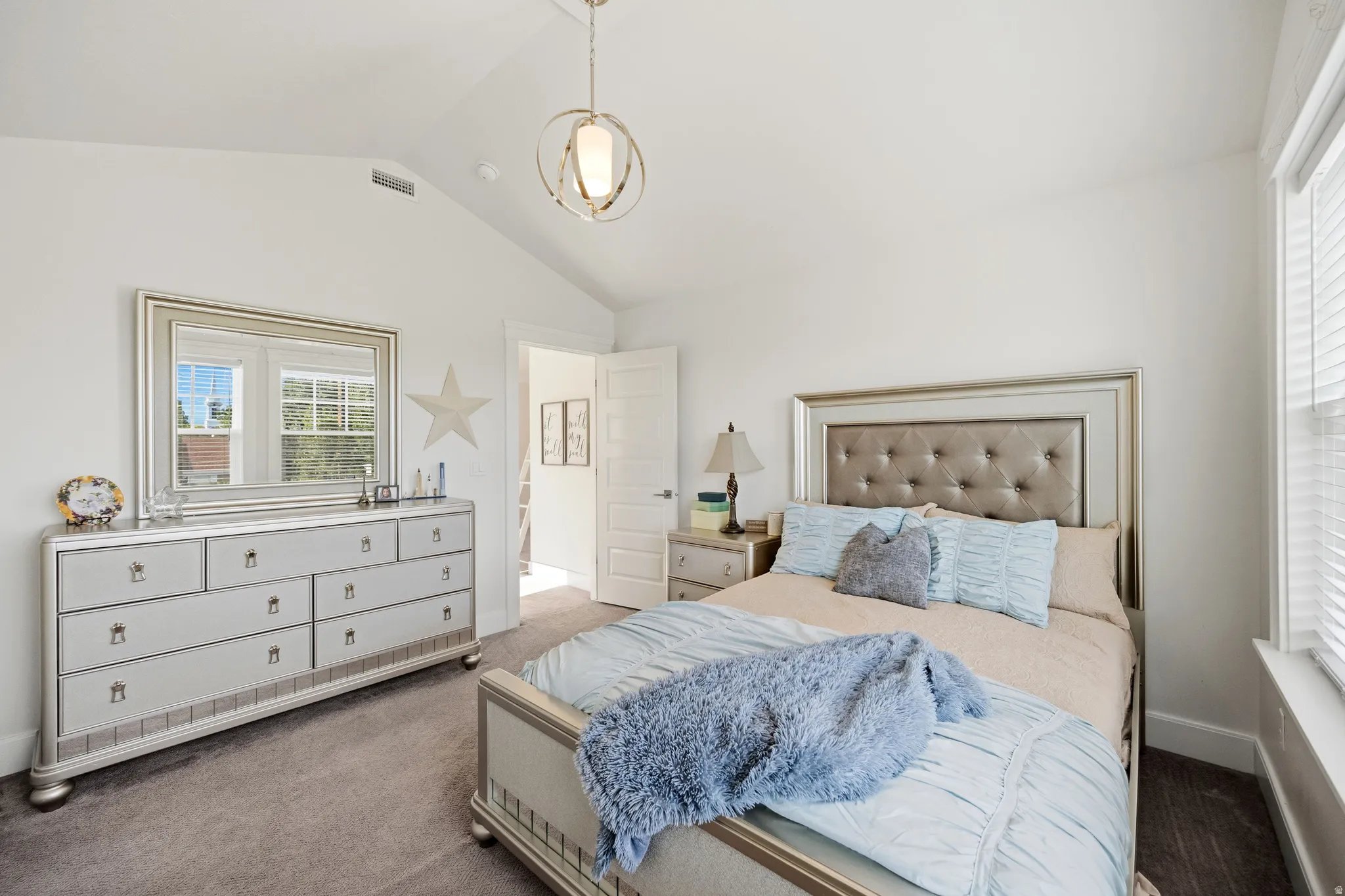 Vaulted ceiling, recessed lighting, double windows with blinds, wood-finish flooring, and a contemporary pendant light fixture